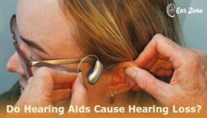 Featured image of a person fitting a hearing aid. Article on Do hearing aids cause hearing loss?