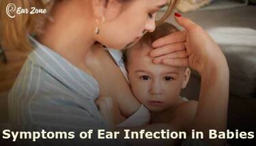 Featured image of a mother touching her baby's forehead for fever. Article on symptoms of ear infection in babies